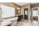 Luxurious bathroom featuring a freestanding tub, glass block window, and walk-in shower at 10784 Giselle Way, Fishers, IN 46040
