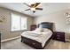 Bedroom includes a ceiling fan, neutral paint, carpet flooring and great natural light from a nearby window at 10784 Giselle Way, Fishers, IN 46040