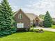 Beautiful brick home with meticulously manicured landscaping and a circular driveway at 10784 Giselle Way, Fishers, IN 46040