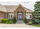 Elegant brick home entrance with a beautiful arched entryway and professionally landscaped surroundings at 10784 Giselle Way, Fishers, IN 46040