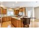 Beautiful kitchen with granite counters, stainless appliances, wood floors, and breakfast bar at 10784 Giselle Way, Fishers, IN 46040