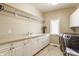 Bright laundry room with counter space, storage cabinets, sink, and modern washer and dryer at 10784 Giselle Way, Fishers, IN 46040