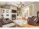 Spacious living room featuring a fireplace, built-in shelving, and hardwood floors at 10784 Giselle Way, Fishers, IN 46040
