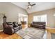 Open-concept living room featuring hardwood floors, large windows, and access to the dining area at 10784 Giselle Way, Fishers, IN 46040