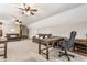 Spacious living room includes two ceiling fans, carpeted flooring, multiple sofas and work desks with lots of natural light at 10784 Giselle Way, Fishers, IN 46040