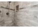 Modern walk-in shower with beautiful tile work, a built-in niche, and a sleek shower head at 10784 Giselle Way, Fishers, IN 46040