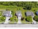 Aerial view of a home with mature trees, manicured lawn, a driveway, and a two-car garage at 10876 Trailwood Dr, Fishers, IN 46038