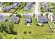 Aerial view of a home with a well-maintained yard featuring a deck, fire pit, and mature trees at 10876 Trailwood Dr, Fishers, IN 46038
