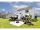 Home's lush backyard showcasing a wood deck, fire pit, and manicured lawn perfect for outdoor enjoyment at 10876 Trailwood Dr, Fishers, IN 46038