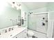 Well-lit bathroom with a shower over tub, white vanity, silver faucet, and decorative mirror at 10876 Trailwood Dr, Fishers, IN 46038