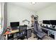 Bright bedroom featuring two desks, a grey chair, and a shelving unit for ample workspace and storage at 10876 Trailwood Dr, Fishers, IN 46038