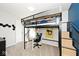 Bedroom with a loft bed, workspace underneath, and a flag hanging from the frame at 10876 Trailwood Dr, Fishers, IN 46038