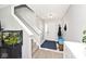 Inviting foyer features neutral walls, a carpeted staircase, and a charming fish tank at 10876 Trailwood Dr, Fishers, IN 46038