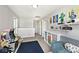Open upstairs loft space with a game machine, Lego decor, and cozy blue sofa at 10876 Trailwood Dr, Fishers, IN 46038