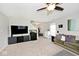 Spacious living room with neutral carpet, a large TV, and an aquarium at 10876 Trailwood Dr, Fishers, IN 46038