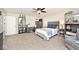 Spacious main bedroom with a ceiling fan, ample closet space, and neutral-toned carpet at 10876 Trailwood Dr, Fishers, IN 46038