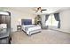 Comfortable main bedroom with neutral carpet, ceiling fan, and large window for natural light at 10876 Trailwood Dr, Fishers, IN 46038