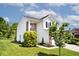 Side view of a charming home with well-maintained lawn, landscaping, and green trees at 10876 Trailwood Dr, Fishers, IN 46038
