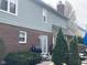 Backyard view featuring siding and brick, a BBQ, a paved patio, and mature landscaping at 11458 Sutton Place W Dr, Carmel, IN 46032