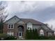 Charming two-story home boasts brick and siding exterior with a well-manicured front lawn at 11458 Sutton Place W Dr, Carmel, IN 46032