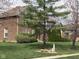 Spacious front yard with a mature tree in a well-manicured lawn at 11458 Sutton Place W Dr, Carmel, IN 46032