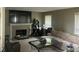Cozy living room features a fireplace with stone surround and ample natural light from large windows at 11458 Sutton Place W Dr, Carmel, IN 46032