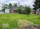 View of the spacious, grassy backyard of the home with a shed and partially fenced in area for added privacy at 121 W Fordice St, Lebanon, IN 46052