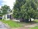 A nice home on a corner lot, partially obscured by mature trees at 121 W Fordice St, Lebanon, IN 46052