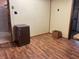 Room featuring wood paneling, a small fridge, and wood laminate flooring at 121 W Fordice St, Lebanon, IN 46052