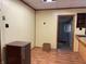 Room featuring wood paneling, a small fridge, and wood laminate flooring at 121 W Fordice St, Lebanon, IN 46052