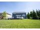 View of the house from the backyard showcasing a large, well-maintained lawn and a deck, perfect for relaxation at 12600 Misty Ridge Ct, Fishers, IN 46037