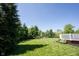 Expansive backyard featuring lush green lawn, mature trees, and a spacious deck, perfect for outdoor gatherings at 12600 Misty Ridge Ct, Fishers, IN 46037