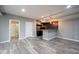 Finished basement with vinyl plank flooring, wet bar, and access to a full bathroom at 12600 Misty Ridge Ct, Fishers, IN 46037