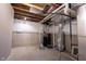 Unfinished basement displaying concrete walls, exposed ceiling, and essential home systems at 12600 Misty Ridge Ct, Fishers, IN 46037
