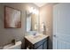 Bathroom with a modern vanity, stylish mirror, decorative artwork, and neutral color palette at 12600 Misty Ridge Ct, Fishers, IN 46037