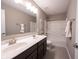 Bathroom with a double sink vanity, a large mirror, and a shower-tub combo at 12600 Misty Ridge Ct, Fishers, IN 46037