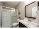 Modern bathroom featuring a shower, a vanity with a dark wood cabinet, and a large mirror at 12600 Misty Ridge Ct, Fishers, IN 46037