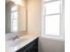 Bathroom featuring a vanity with granite countertop, mirror, and window at 12600 Misty Ridge Ct, Fishers, IN 46037