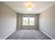 Bedroom featuring a window for natural light and soft gray carpeting at 12600 Misty Ridge Ct, Fishers, IN 46037