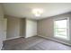 Bedroom with a window for natural light, soft gray carpeting, and sliding door closet at 12600 Misty Ridge Ct, Fishers, IN 46037