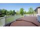 View of a large deck with white railings overlooking a green backyard, great for outdoor enjoyment and relaxation at 12600 Misty Ridge Ct, Fishers, IN 46037
