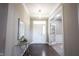 Inviting entryway with hardwood floors, a glass table, and an open doorway to another room at 12600 Misty Ridge Ct, Fishers, IN 46037