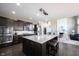 Open-concept kitchen with a large island, dark cabinetry, and stainless steel appliances at 12600 Misty Ridge Ct, Fishers, IN 46037