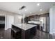 Modern kitchen features a large island with seating and stylish pendant lighting at 12600 Misty Ridge Ct, Fishers, IN 46037