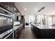 Open kitchen with stainless appliances, granite counters, and island open to living area at 12600 Misty Ridge Ct, Fishers, IN 46037