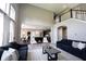 Spacious living room with soaring ceilings, large windows, and open floor plan to kitchen at 12600 Misty Ridge Ct, Fishers, IN 46037