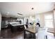 Bright kitchen and dining area with an island, dark cabinetry, and stylish decor at 12600 Misty Ridge Ct, Fishers, IN 46037