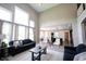 Bright living room featuring tall windows, soaring ceilings, and view into the kitchen at 12600 Misty Ridge Ct, Fishers, IN 46037