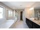 Primary bathroom with a double sink vanity, soaking tub, and glass-enclosed shower at 12600 Misty Ridge Ct, Fishers, IN 46037