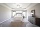 Main bedroom showcasing a tray ceiling, neutral walls, and plenty of natural light at 12600 Misty Ridge Ct, Fishers, IN 46037